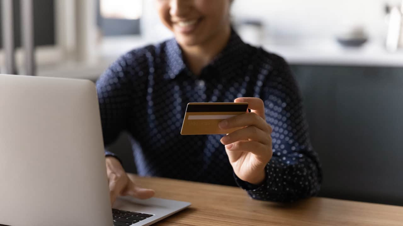 Customer paying by card while shopping online on a laptop