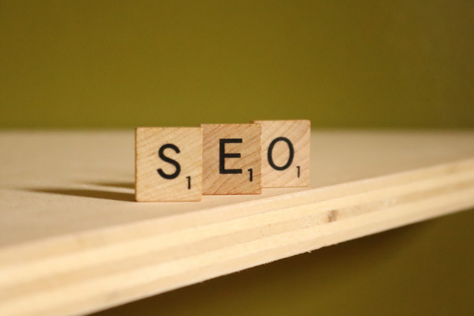 Wooden tiles spelling SEO on a shelf
