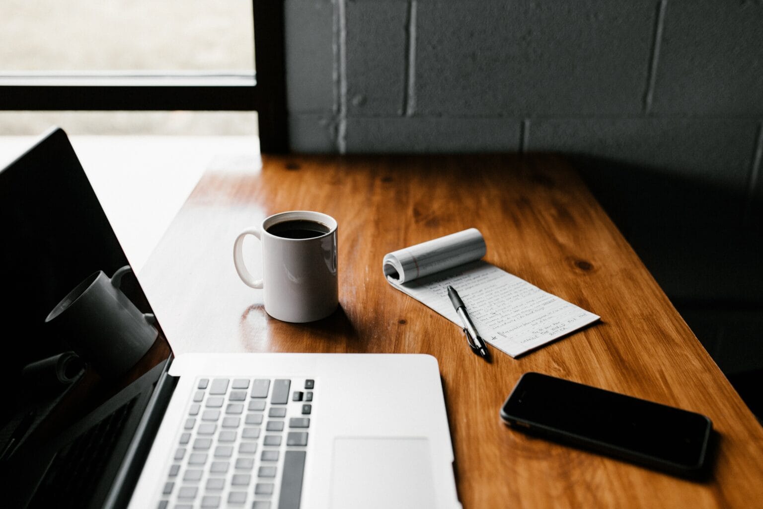 Website redesign layouts on a laptop for a Charleston company